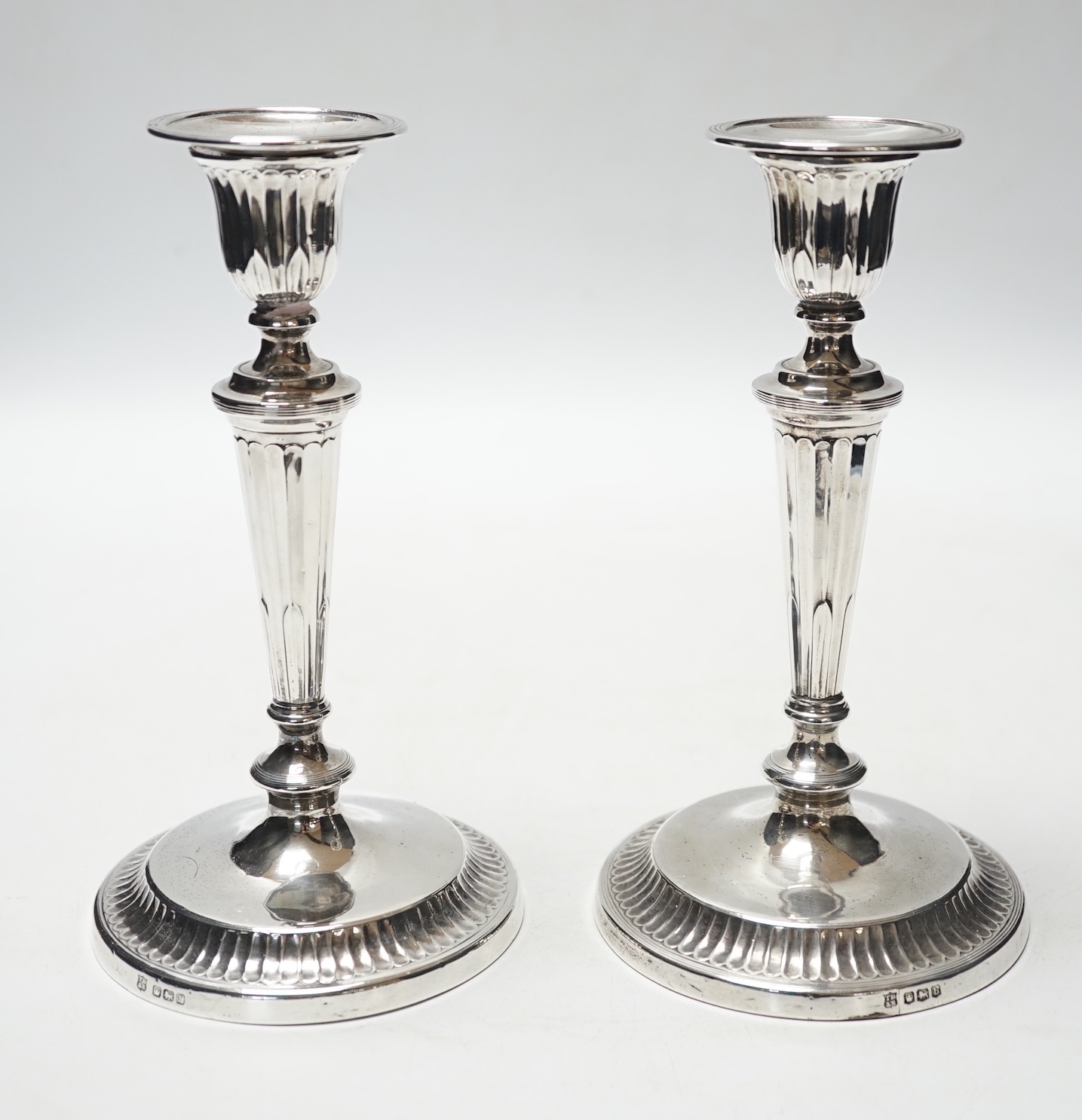 A pair of George V silver mounted candlesticks, Thomas Bradbury & Sons, Sheffield, 1919, 18.6cm, weighted.